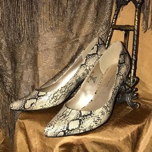 Apostrophe faux snakeskin heels.